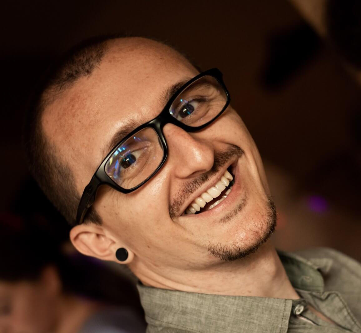 Marko, certified ESL and communication coach, smiling confidently in profile photo